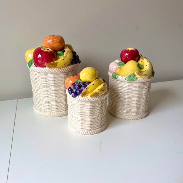 Vintage ceramic wicker and fruit motif canister set with three different sizes. The pieces are produced by Fitz & Floyd...