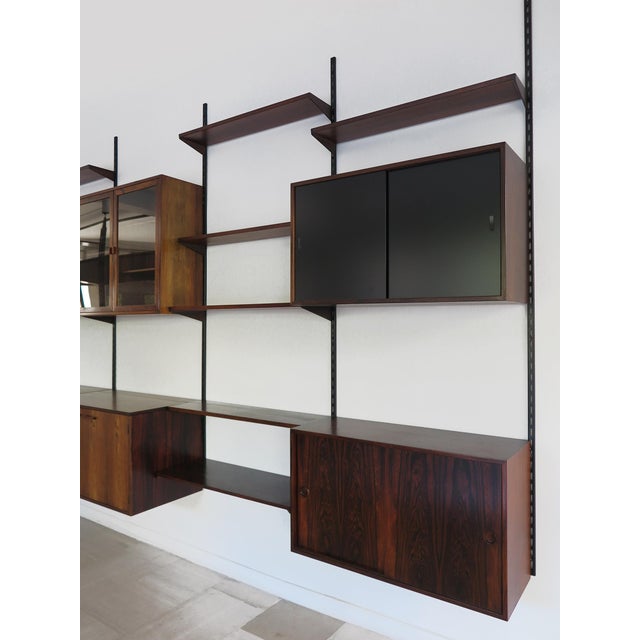 Scandinavian bookshelf in dark wood designed by Kai Kristiansen and manufactured by FM Mobler, consisting of 8 shelves of...