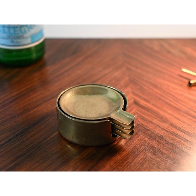 Wonderful and unique set of four stackable ashtrays in solid brass. This stylish and versatile set was produced in Austria...