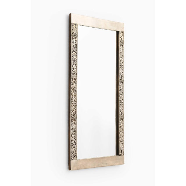This rare and decorative mirror, designed by swedish artist david wretling in the 1920s, is a striking example of early...
