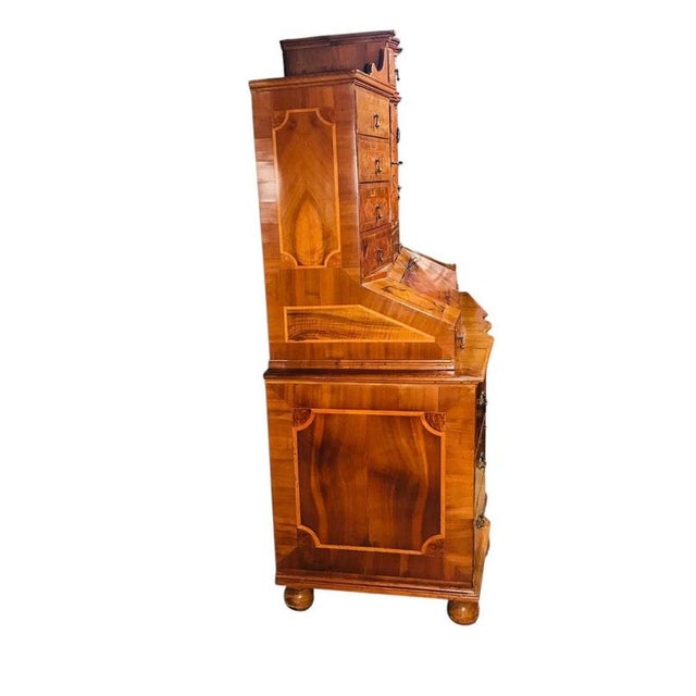 This impressive Baroque walnut marquetry secretary desk combines sophisticated craftsmanship with remarkable...