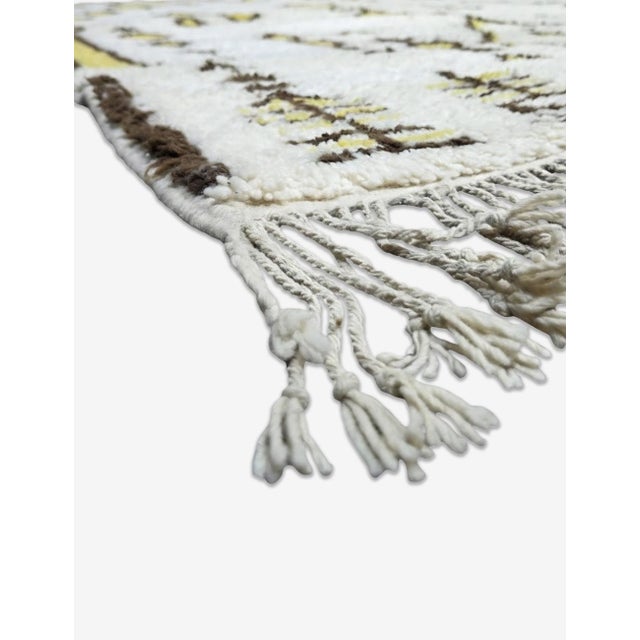 Boujad Rug | Handwoven Berber Wool Rug with Ivory Field and Tribal Symbols This richly detailed Boujad rug features an...