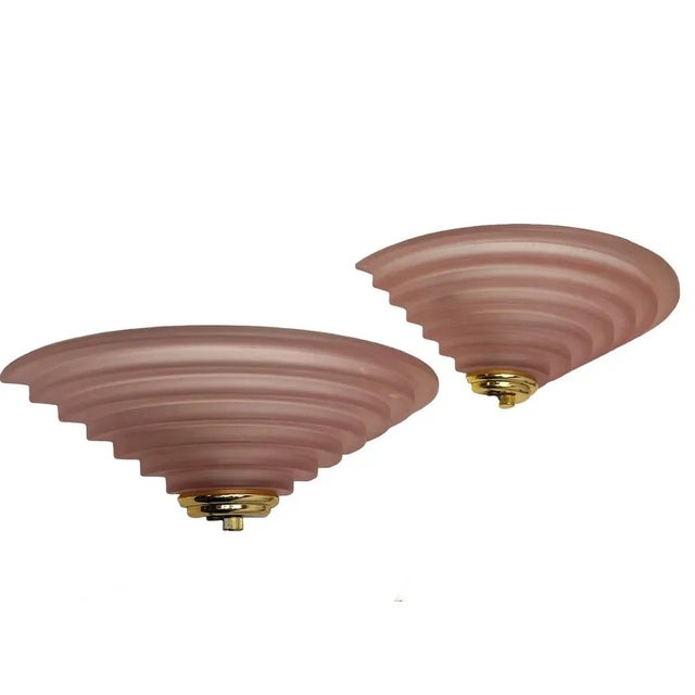 A set of Wall Lights stepped Salmon Pink Frosted Glass with brass accents. These were designed and made by Happylight in...