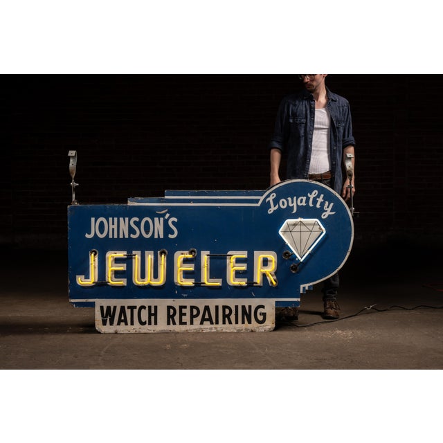 Double-sided projecting neon trade sign reading "Johnson's Jeweler - Watch Repairing" with secondary "Loyalty" diamond...