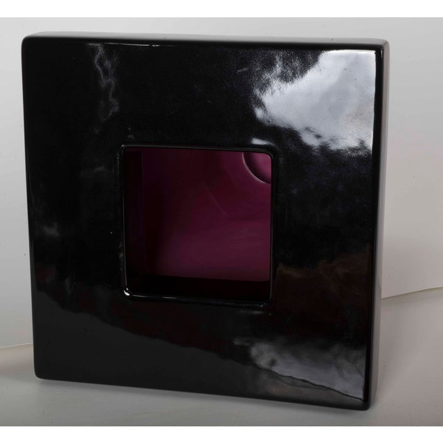 Made of pink and black glazed ceramic, it stands out for its striking geometric and architectural composition,...