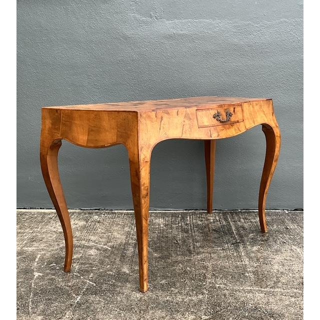 This exquisite Italian writing desk is a masterclass in Rococo-inspired design, featuring a graceful serpentine silhouette...