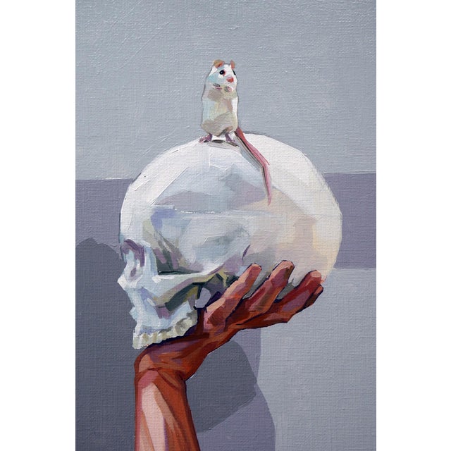In "Unexpected Links," a woman gazes thoughtfully at a skull she cradles in her hand, while a small mouse perches atop it,...