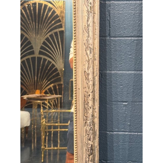 Beautiful 19th century silver Louis Philippe mirror. This piece has a pretty floral pattern and a beaded inner border. A...