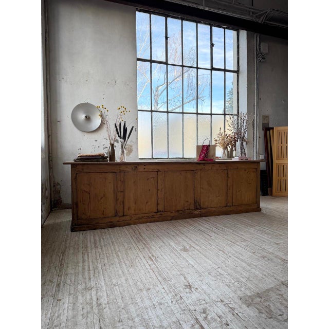 Antique, very large pine shop counter dating from 1900. we love its generous size, with its paneled fronts. with its...