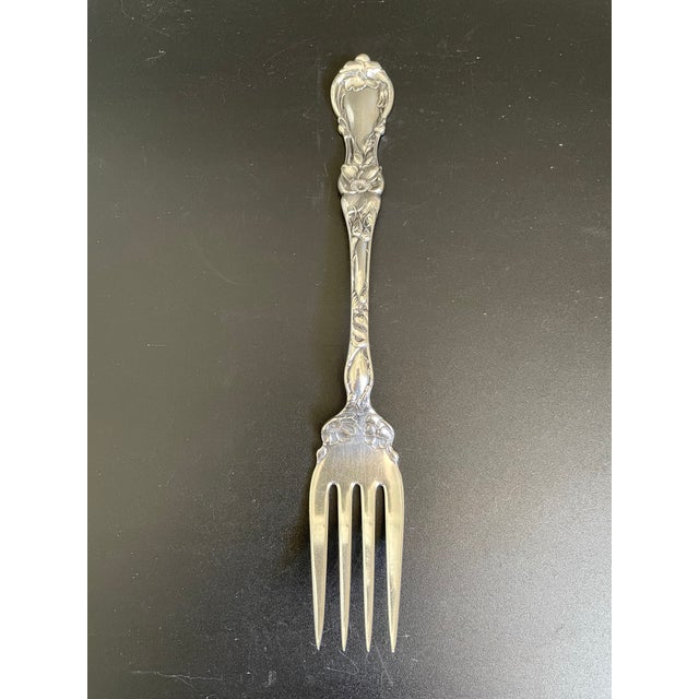 Antique cold meat serving fork in the Floral pattern by Wallace Silver. This exquisite piece features an elaborate design...