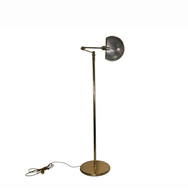 Mid-century adjustable floor lamp attributed to Leuchten, Germany. Solid brass construction with a slender upright and...