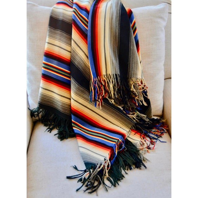 Unusual antique wool stripped carriage blanket in wonderful coloring. It has hand-knotted fringe on the two warp ends and...