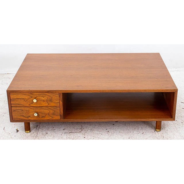 A sophisticated mid-century walnut low table designed by Edward J. Wormley (American, 1907–1995) for Dunbar Furniture....
