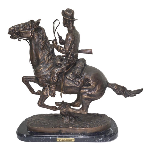 A finely detailed bronze sculpture after Frederic Remington’s Trooper of the Plains. Measuring 20" x 9" x 18", this...