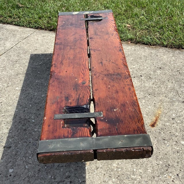 A true antique with a lot of character. 2 inch thick Paine with lifting cleats in place resting on 2 solid iron scroll...