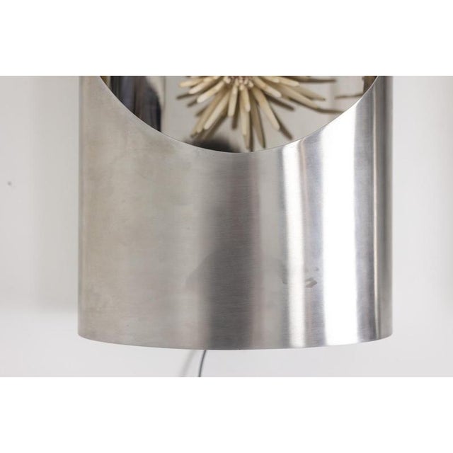 Pair of large polished metal wall sconces decorated with sea urchins. French work from the 1970s. Design. Chic decoration....