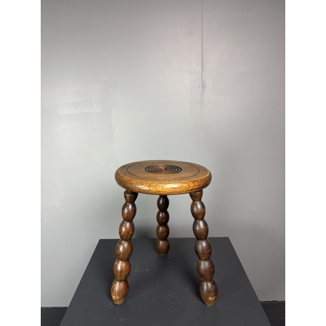 Lovely French oak stool most likely from the Breton area, 1950s. This piece is designed in the style of the selected...