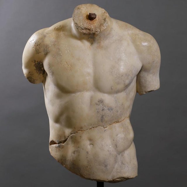 Sculpture of a male torso in the Hellenistic style. Sculpture on base of a male torso in the Hellenistic style, plaster...