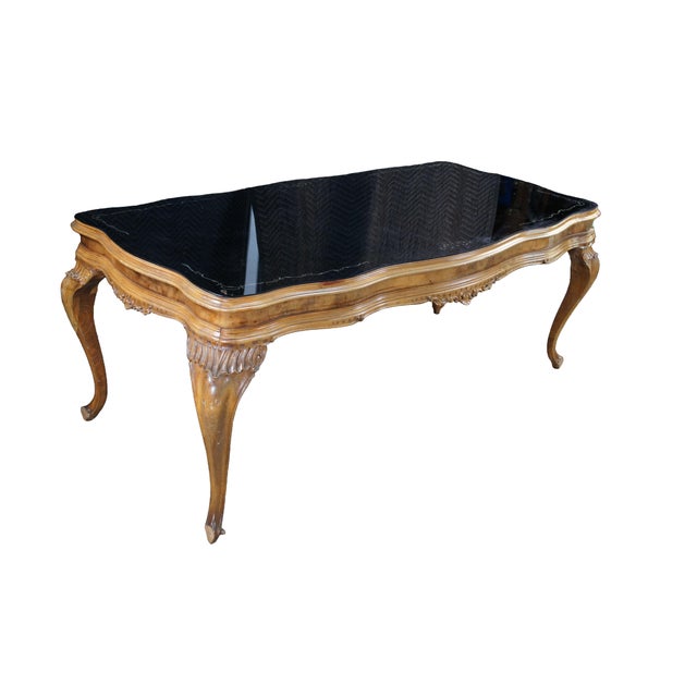 An impressive Early 20th century Italian Baroque Rococo dining table, circa 1920s. Features a serpentine form with reverse...