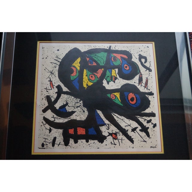 A vivid lithograph of Joan Miro's Agora 1. This piece is well framed in a chrome and mirrored frame and is ready to hang....