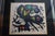 A vivid lithograph of Joan Miro's Agora 1. This piece is well framed in a chrome and mirrored frame and is ready to hang....