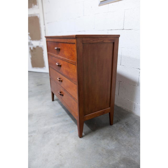 1960s oak chest of drawers with a cherry varnish finish. It is sturdy and beautiful with its wooden handles. Width 92cm...