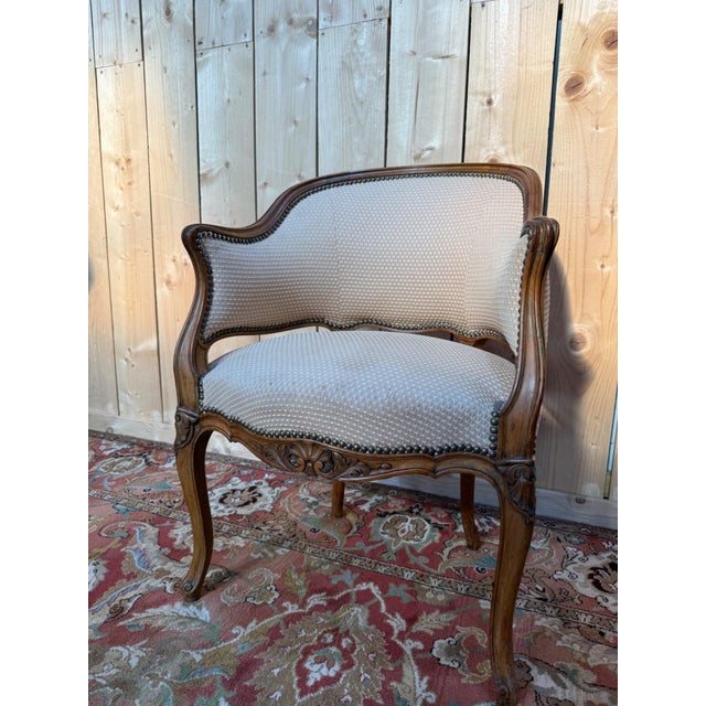 A louis xv style "corbeille" desk chair, 19th century, with a walnut frame and honey-brown patina. cabriole legs, a carved...