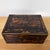 A handsome antique Victorian box featuring richly Coromandel wood in dramatic shades of deep brown, black, and warm amber....
