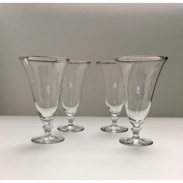 This classic set of vintage water glasses has a tapered shape that is trimmed in silver on a round foot and adds an...