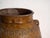 This antique Chinese glazed stoneware vase is an ovoid jar with a ochre-amber glaze, lug handles and stamped decoration of...