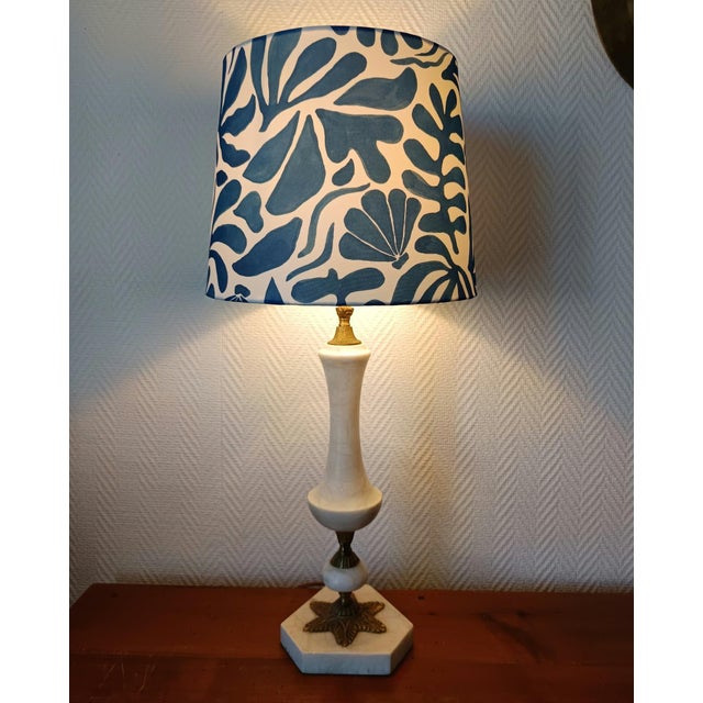 Tapered lamp base in white alabaster with a gilt brass mount. Custom-made Empire-style lampshade in a blue Matisse-style...