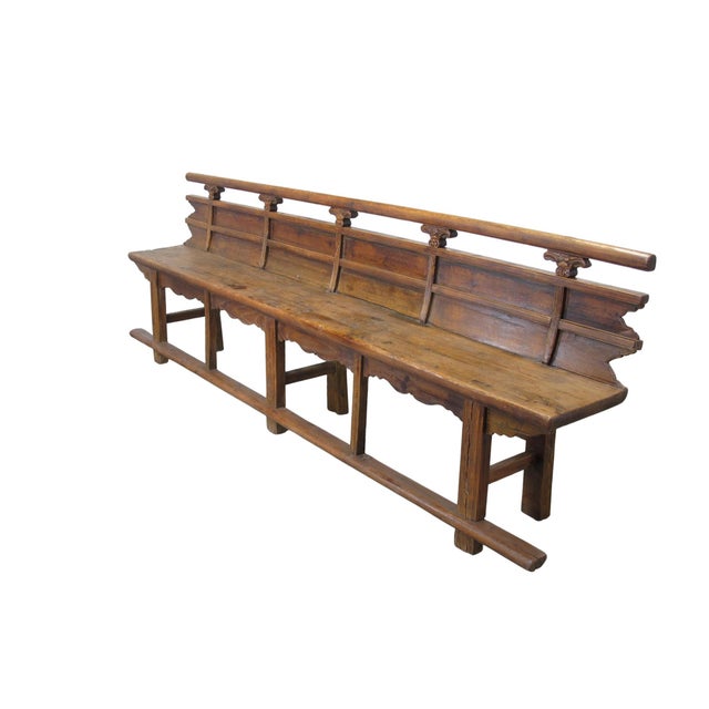This antique Chinese bench showcases a blend of traditional craftsmanship with its decorative hand-carved spandrels. Made...