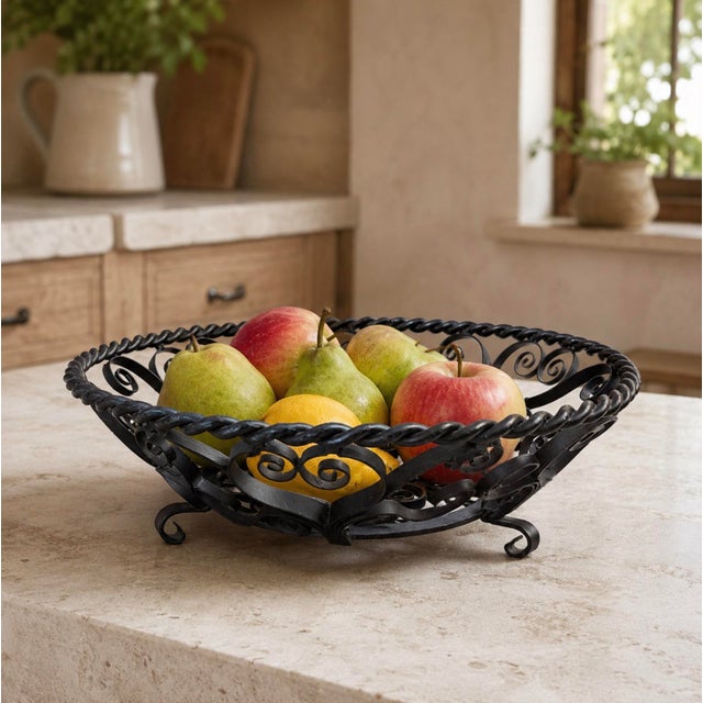 This vintage German wrought iron basket features elaborate hand-shaped scrollwork, a twisted-rope rim, and charming curled...