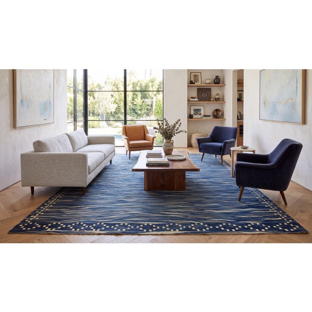 Elevate high-end interiors with this stunning modern flat-weave Kilim wool rug, featuring an organic, wave-inspired linear...