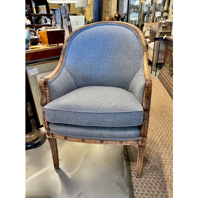 This is an exceptional pair of early twentieth century French Empire Bergeres. The walnut frames are beautifully detailed...