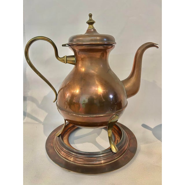 This is an early 20th-century Swedish copper and brass coffee service by Oscar Nilsson of Eskilstuna, Sweden, a metalworks...