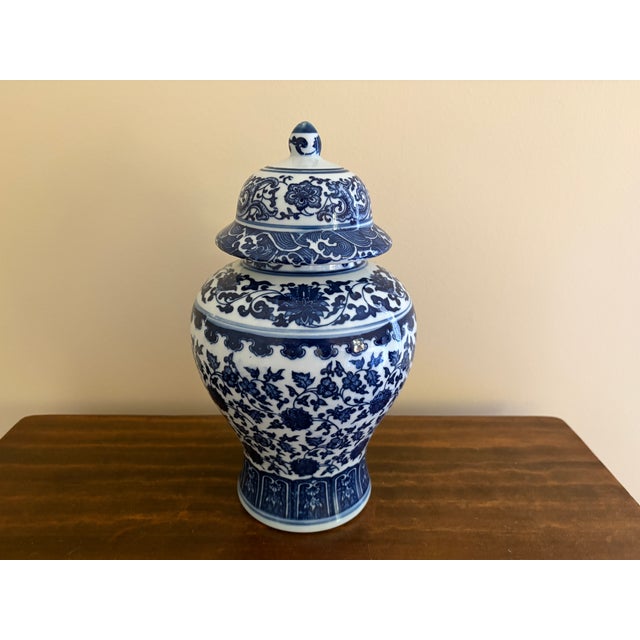 A classic blue and white ginger jar, decorated throughout with a delicate flowering branch motif. The pattern is dense yet...