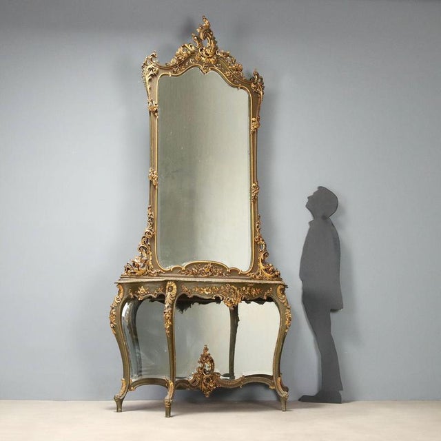 Console with mirror in Barocchetto style, crafted from carved, lacquered, and gilded wood, represents a refined example of...