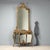 Console with mirror in Barocchetto style, crafted from carved, lacquered, and gilded wood, represents a refined example of...