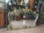 Great mirror with golden brown frame carved and worked with central shelf Italie 1950 Detail for carving reminiscent of...