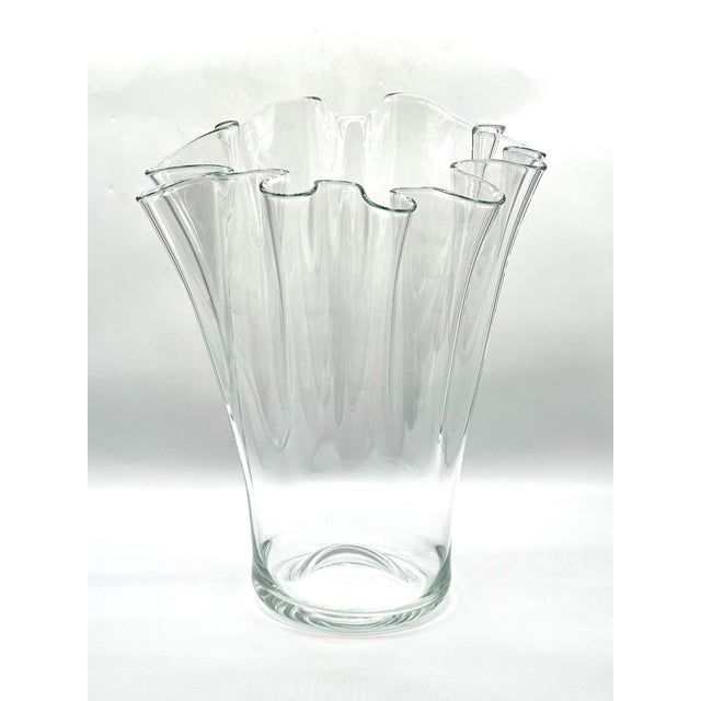 An imposing, monumental floor vase made of heavy, mouth-blown solid glass. The piece captivates with its freely formed...