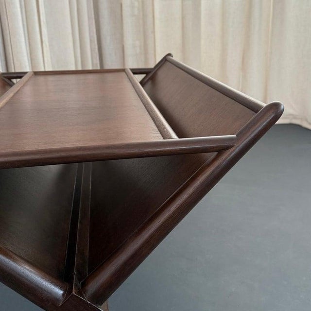 This stunning Mid-Century Modern magazine rack side table was designed by the British born architect and furniture...