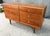 This Mid-Century Modern Drexel Declaration walnut dresser features six drawers arranged in a balanced double-bank design....