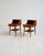 Pair of Swedish teak nightstands with a mahogany backsplash, a front drawer with a brass handle, and a slatted lower...