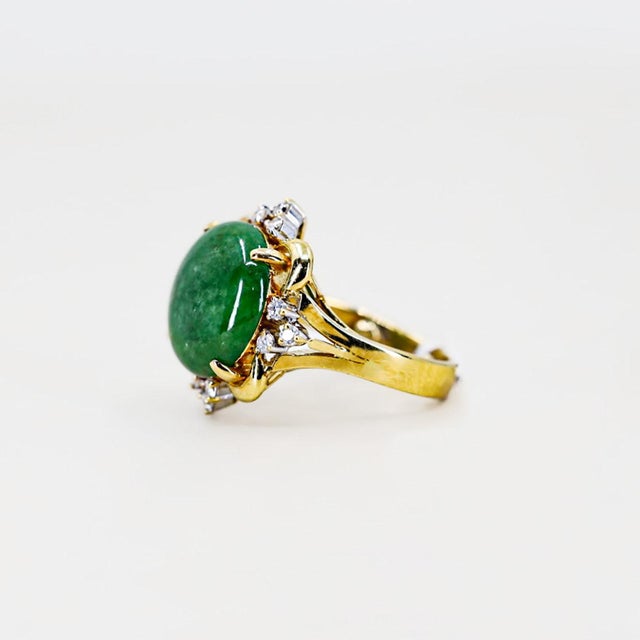 18K Ring with approximately 8.00 carat jade cabochon and 12 round diamonds weighing 0.18 carats. 9.02 grams