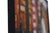 Dividing Lines by Stefan Smit | Oil on Panel Woman standing in front of striped columns in a cityscape. For Sale - Image 4 of 4