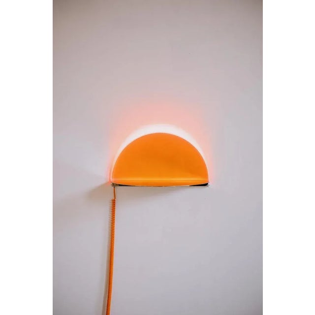 Sunset wall light by amber dewaele dimensions: d 62 x w 32 x h 34 cm. Materials: acrylic and polished stainless steel....