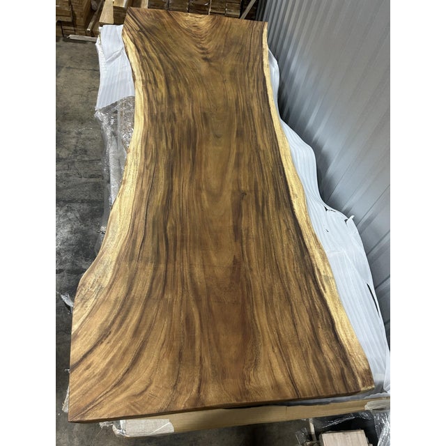 One tree. One top. One of one. A true single-slab live edge table: one continuous cross-section of a single Saman tree...