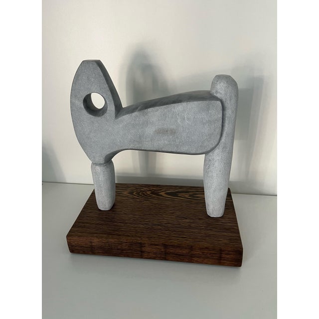 Beautiful Mid-Century Modern marble sculpture in the likeness of a sheep resting on a dark walnut wood base. Created by...