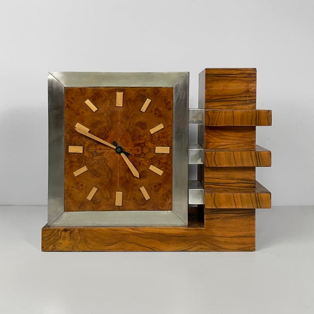 Italian Art Deco wooden and metal table clock, 1930s Table clock with rectangular base in wood with metal details. The...
